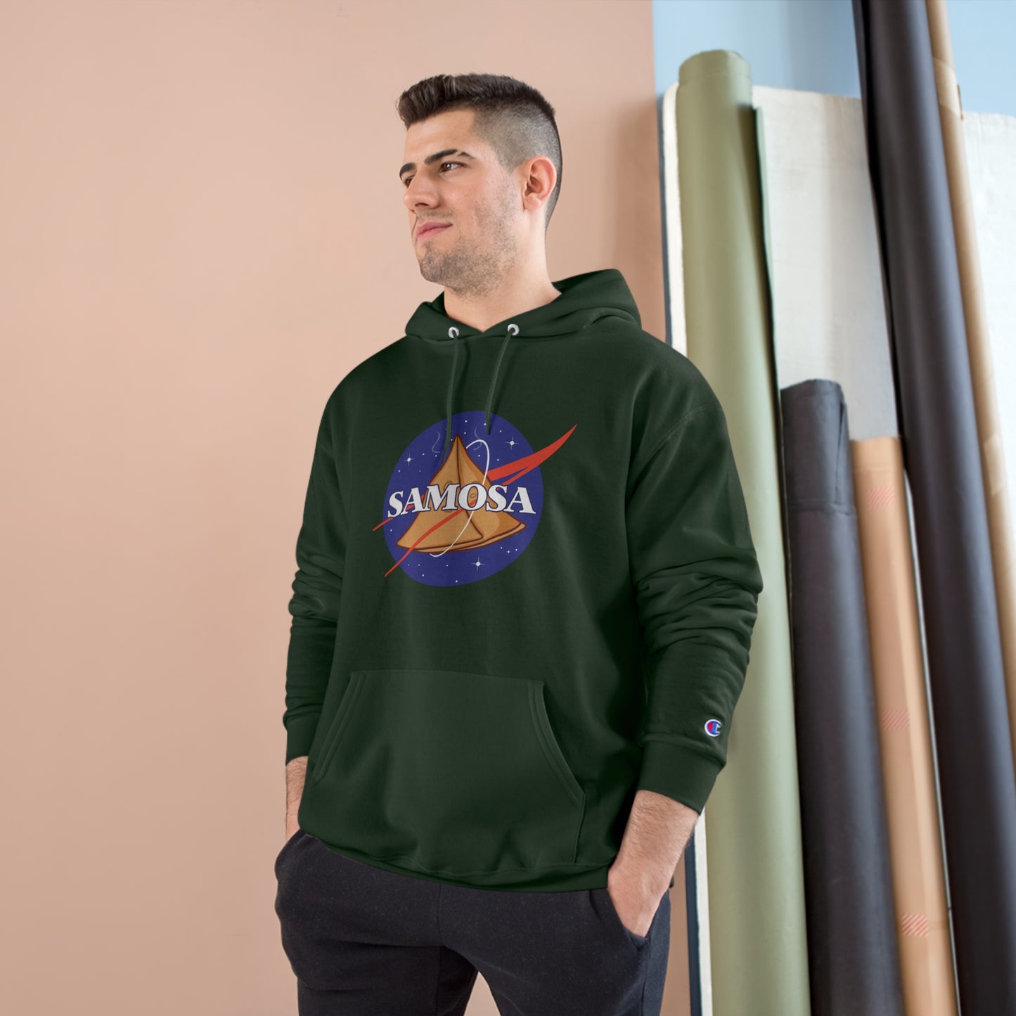 Model wearing NASA Samosa Champion hoodie with space-themed design and spacious pocket, showcasing cozy style.