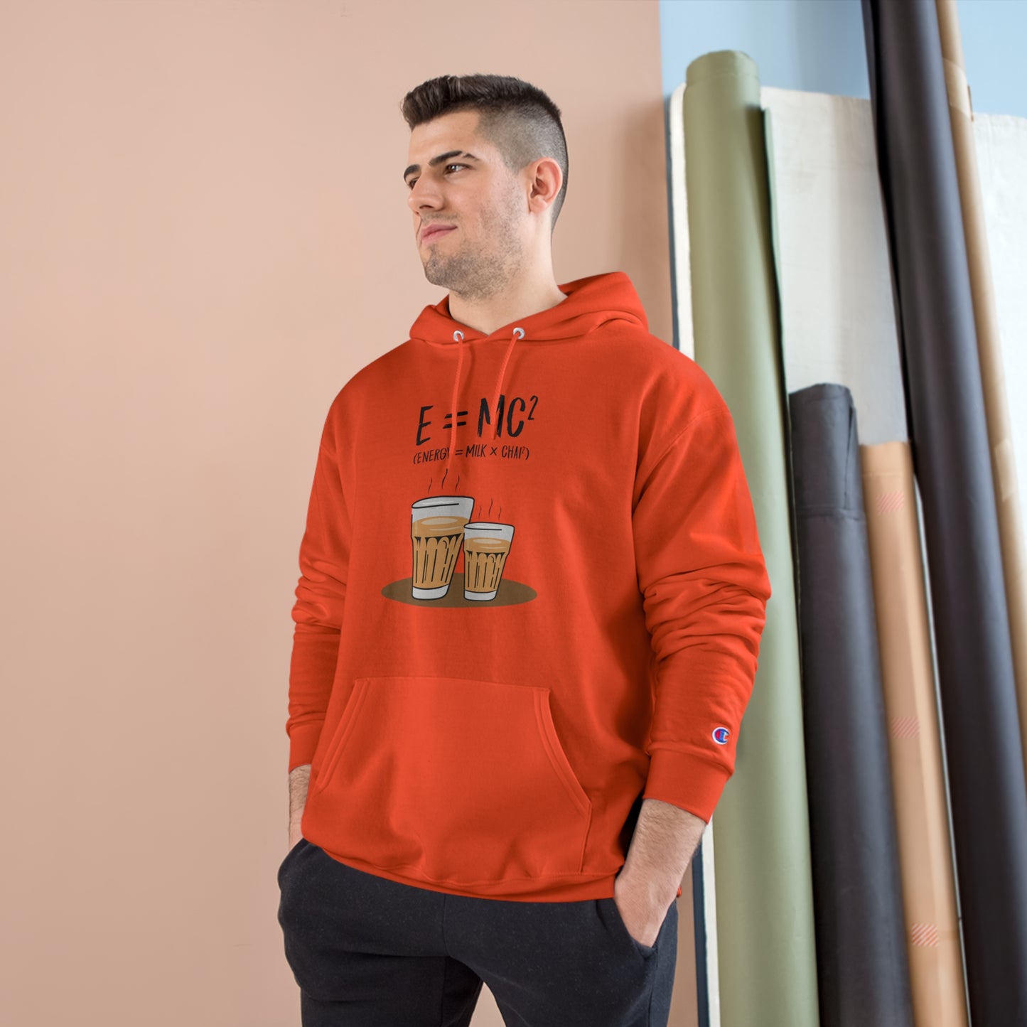 Model wearing an E=M*C champion hoodie with beverage graphic, showcasing cozy style and comfort.