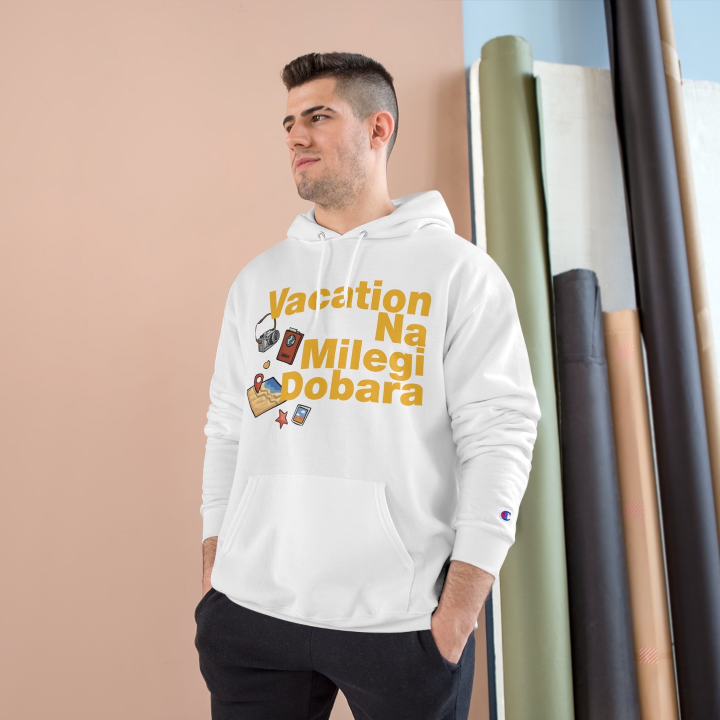 Man wearing white VNMD Champion hoodie with travel-themed graphics, perfect for adventures and journeys.