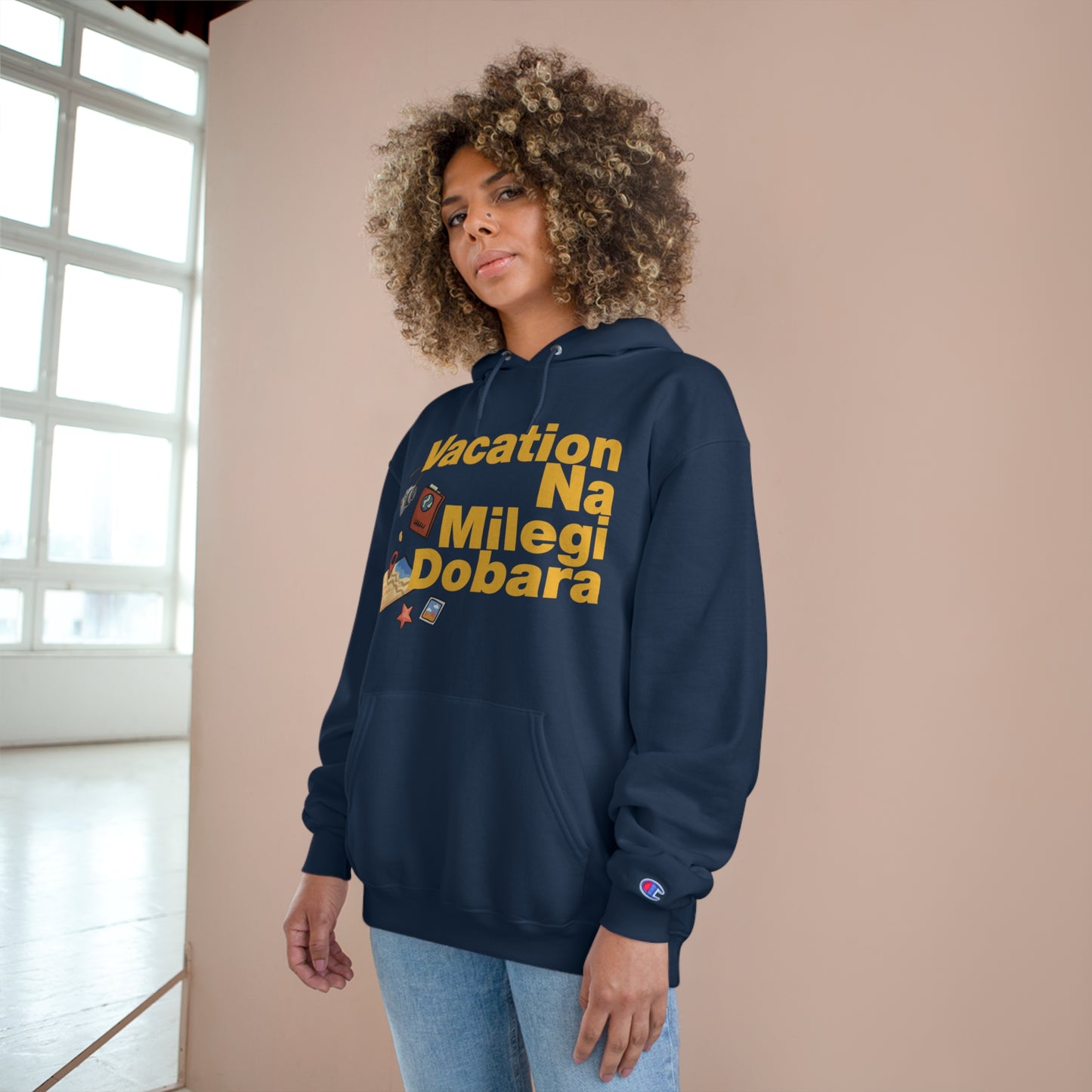 Model wearing VNMD Champion hoodie with "Vacation Na Milegi Dobara" print, showcasing style and comfort for travelers.