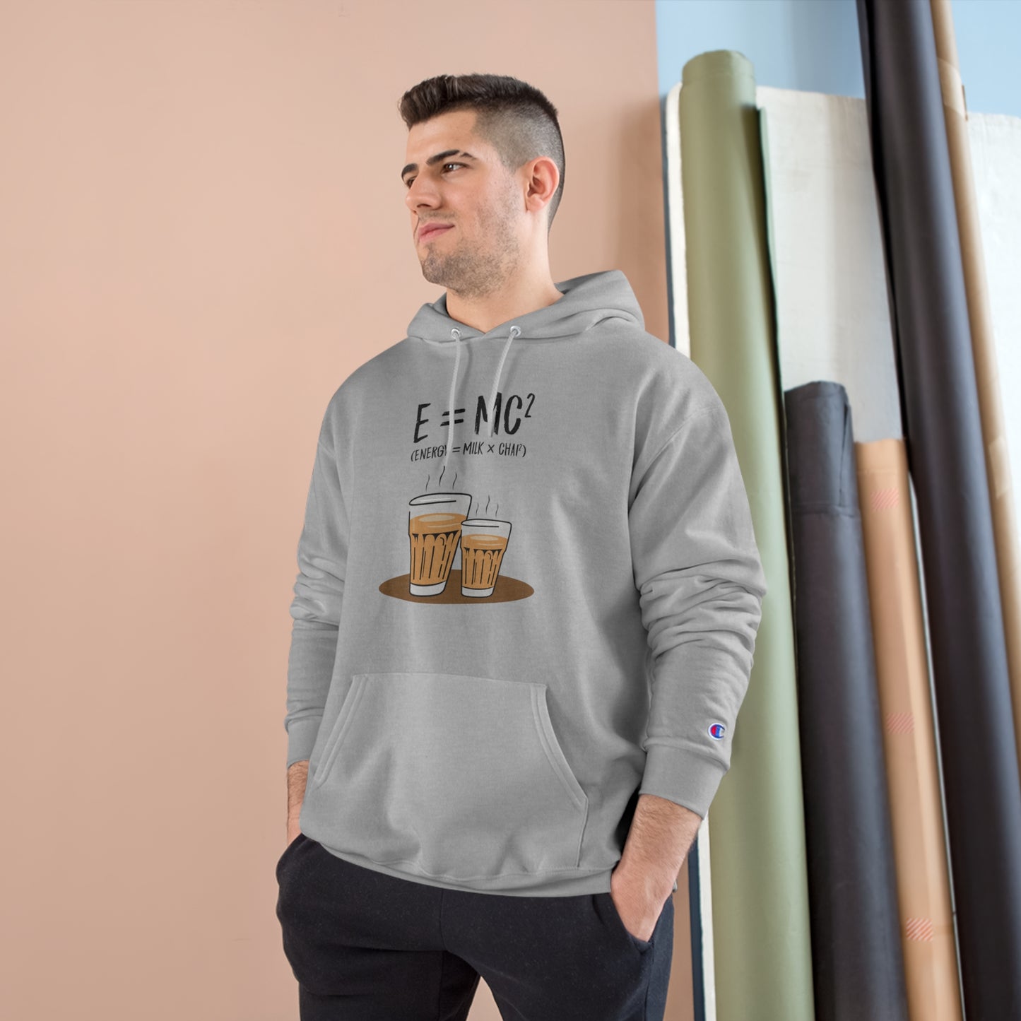 Man wearing E=M*C Champion hoodie with chai graphic, showcasing cozy design and iconic "C" logo.
