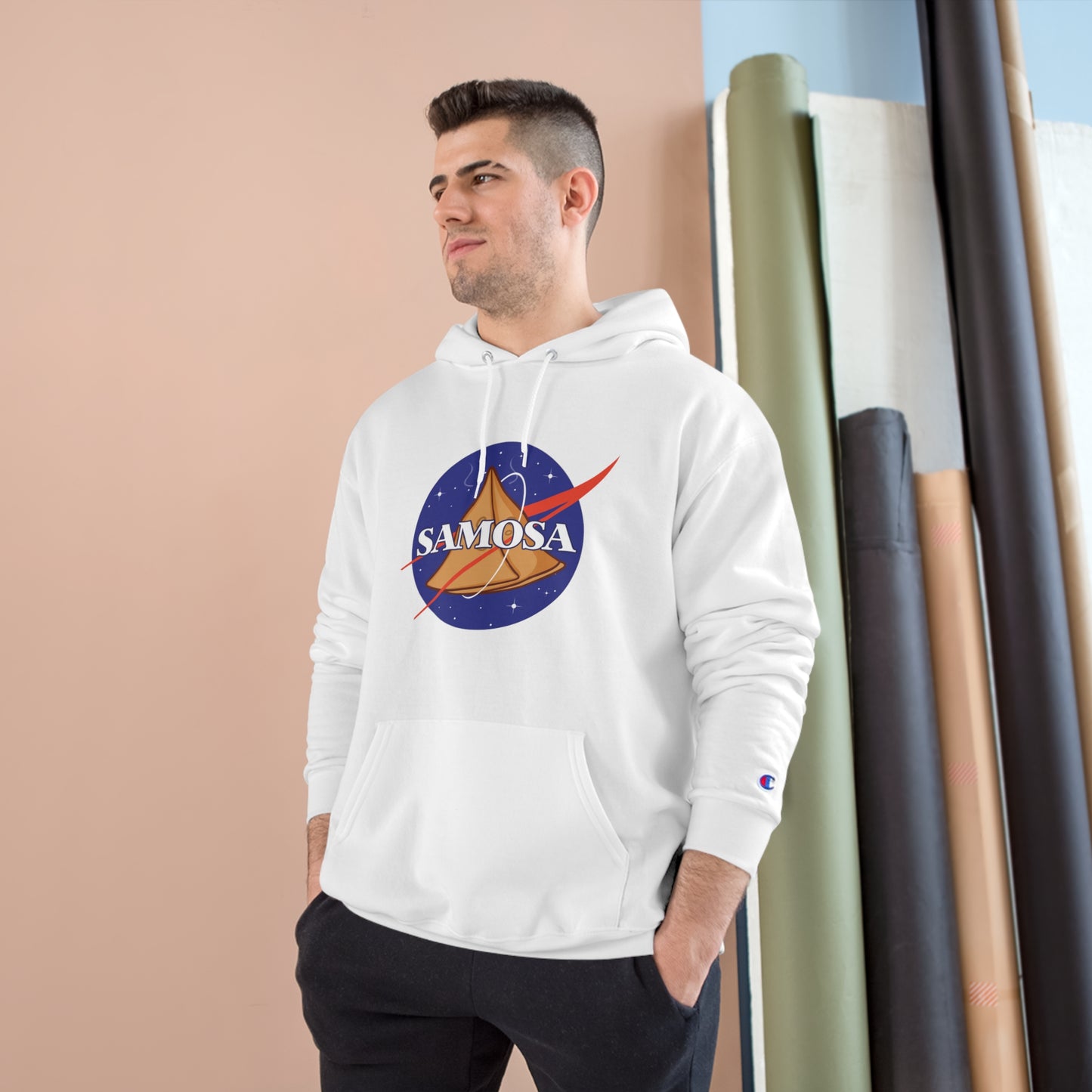 Man wearing NASA Samosa Champion hoodie, featuring a space-themed graphic and spacious pocket, designed for warmth and comfort.