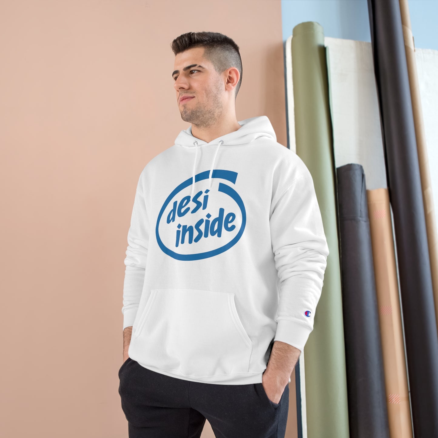 Model wearing white 'Desi Inside' Champion hoodie, showcasing cozy design and spacious pocket, perfect for any occasion.