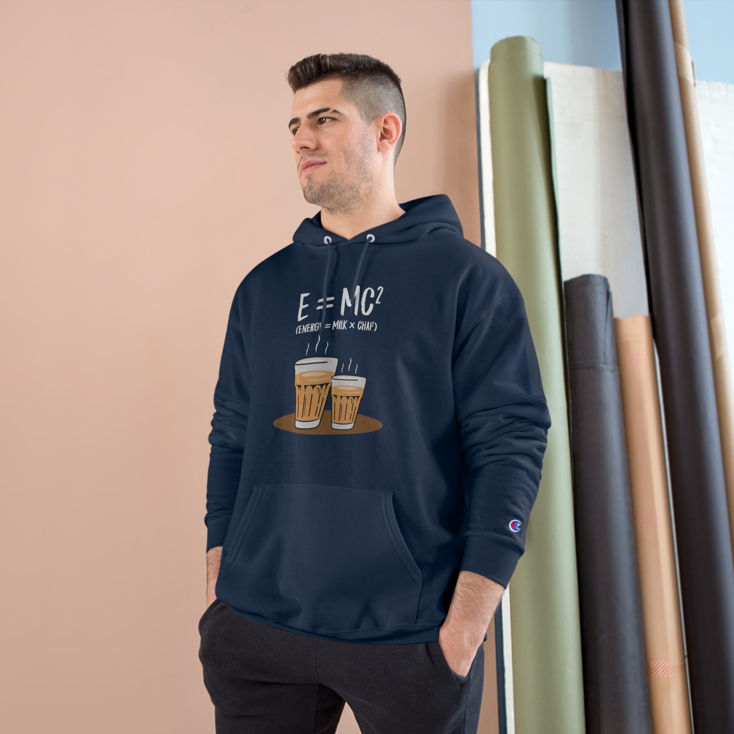 Man wearing E=M*C Champion hoodie featuring chai graphic, perfect for chai lovers and cozy comfort.